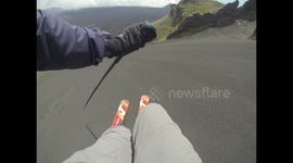 Man skies down ashy slope on Mount Etna