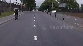Boy racer dangerous driving racing motorcycles and nearly hitting a cyclist