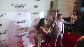 Salma Hayek-Pinault attempts to keep the photographers quiet to stop them from disrupting the movie at the premiere of Septembers of Shiraz at the Museum of Tolerance in Los Angeles, CA