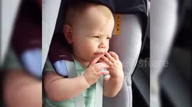 Cute baby makes noises with fingers and mouth