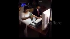 Newlyweds play computer games at an internet cafe