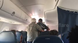 'Unruly' passenger is escorted out of plane by police
