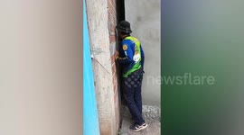 Stay dog squashed between two walls rescued by locals