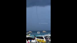 Waterspout tornado stretches to the sky on Thai beach