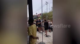 Tourists queue for ferry tickets as Indonesia volcano eruption grounds flights