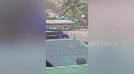 Residents tie down roofs as Super Typhoon Usagi approaches the Philippines