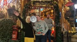 The famous Kensington pub festooned with over 80 trees switches on festive lights with a delighted crowd