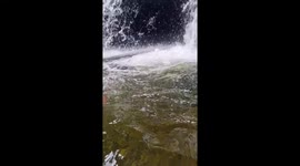 Waterfall Submerges Unsuspecting Swimmer