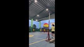 Teams play volleyball with giant inflatable ball