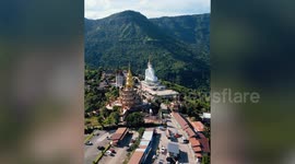 Giant white Buddha sits on roof of this mountain-top Thai temple