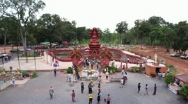 Giant mythical serpent Phaya Naga sits in middle of pond at Thai temple