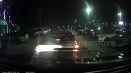 Car backs up in parking lot without checking mirrors and nearly backs in to another car but gets saved by proactive driver