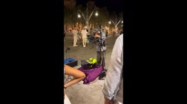 Old man busks in Barcelona with a puppet playing piano