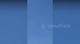 Pilots' parachutes tangle mid-air sending them plunging towards the ground
