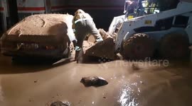 Firemen recover cars covered in mud from DANA flood in Spain