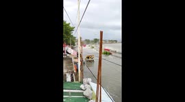 Giant sea wave cascades into road and swallows passing fire truck
