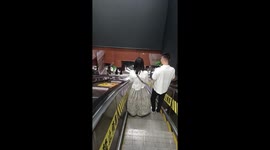 Woman falls down escalator while taking selfie