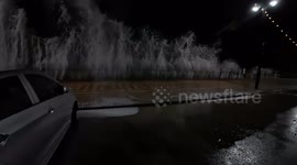 Motorist's feet soaked as huge wave crash over seawall in east England