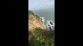 People take wedding photos on cliff in Fujian Province, China