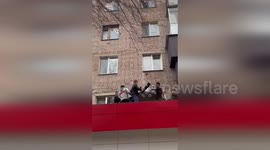 Neighbours use blanket to catch boy leaping from burning building
