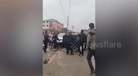 China school car crash driver attacked by parents