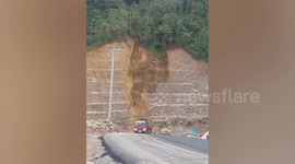 Cliff landslide buries road in Indonesia