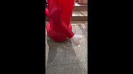Chinese man plays rock paper scissors with inflatable balloon figure