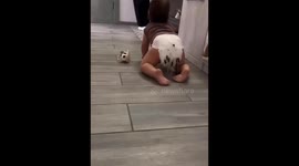 Child crawling with eyelash brushes stuck to diaper in Perm, Russia