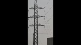 Drunk person climbs electrical transmission tower in Noida, India