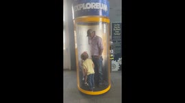 Brother takes care of frightened younger sister inside hurricane simulator