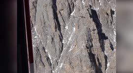 Air crane helicopter removes mountain shelter in Italy