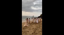 Bride hands boquet to friend for boyfriend to make surprise proposal