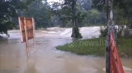 Heavy rain causes river to rise flooding bridge in Guatemala
