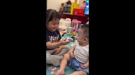 Sister sticks spinning fan toy on brother’s forehead in China