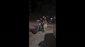 Three ladies struggle to move motorcycle in Aizawl, Mizoram, India