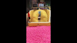 Trampoline game in Guangzhou sends one person soaring into foam balls.