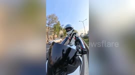Motorcyclist halts traffic to rescue kitten stranded on busy road