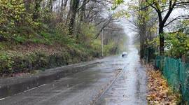 Vehicles driving through a lot of standing water on the road