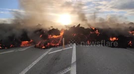 Lava spills across road in Iceland from volcano eruption