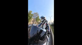 Chinese woman rescues kitten while riding motorcycle