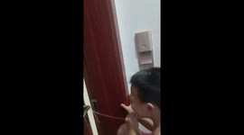 Chinese mother helps child pull loose tooth