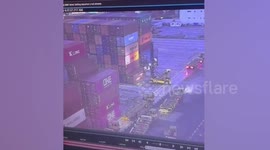 Crush terror as shipping containers smash onto docker's forklift truck