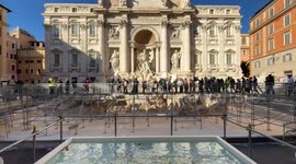 Tourists on the walkway built over the Trevi Fountain during the Jubilee cleaning works in Rome.