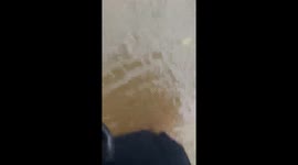 Locals wade through severe floods in southern Thailand