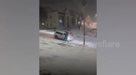 Massive pile-up as SUVs slide down icy road in the snow