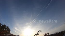 Time lapse camera captures aircraft contrails and a sun halo in Leeds,UK
