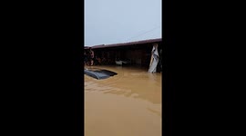 Floods submerge cars and excavators nearly sunk in Medan, Sumatra Utara, Indonesia