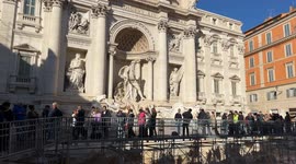 Tourists on the walkway built over the Trevi Fountain during the Jubilee cleaning works in Rome.