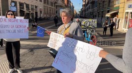 Women of Georgian origin hold signs protesting the results of the Georgian elections in an impromptu sit-in in Rome.