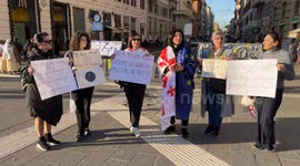 Women of Georgian origin hold signs protesting the results of the Georgian elections in an impromptu sit-in in Rome.